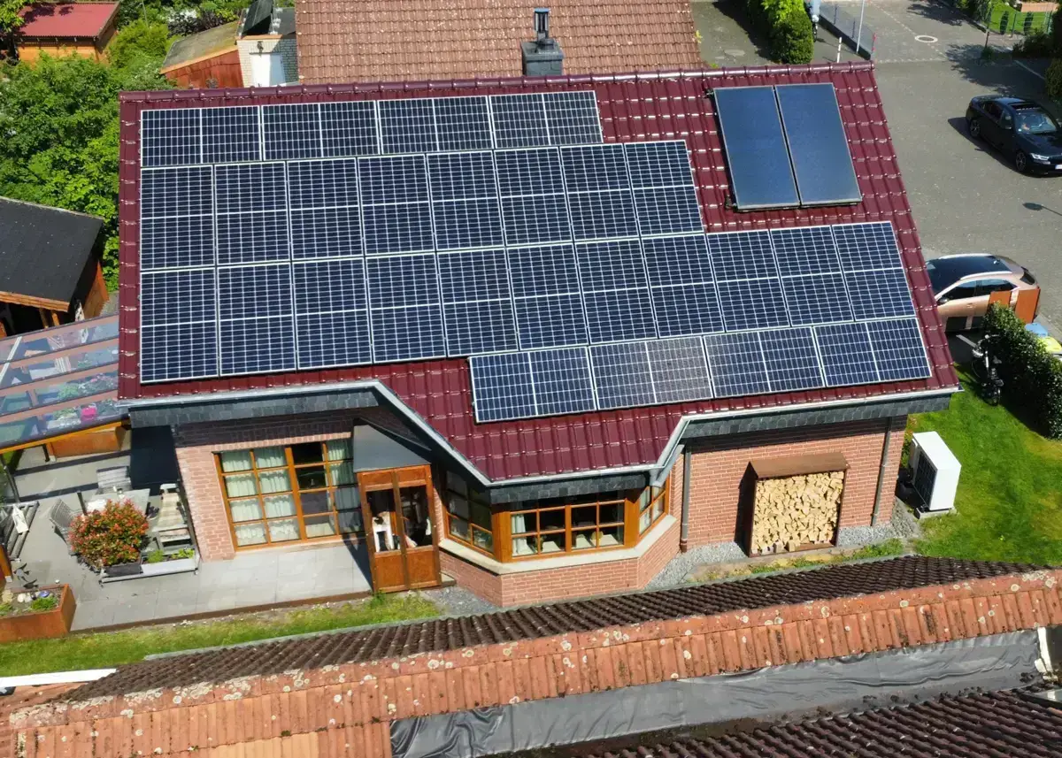 Einfamilienhaus mit Solarpaneelen auf dem Dach, nachhaltige Energieerzeugung durch Solarstrommodule.